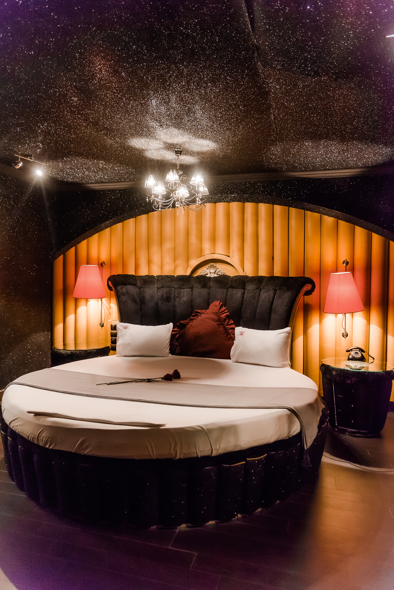 Ruby Rooms themed suite with a round bed
