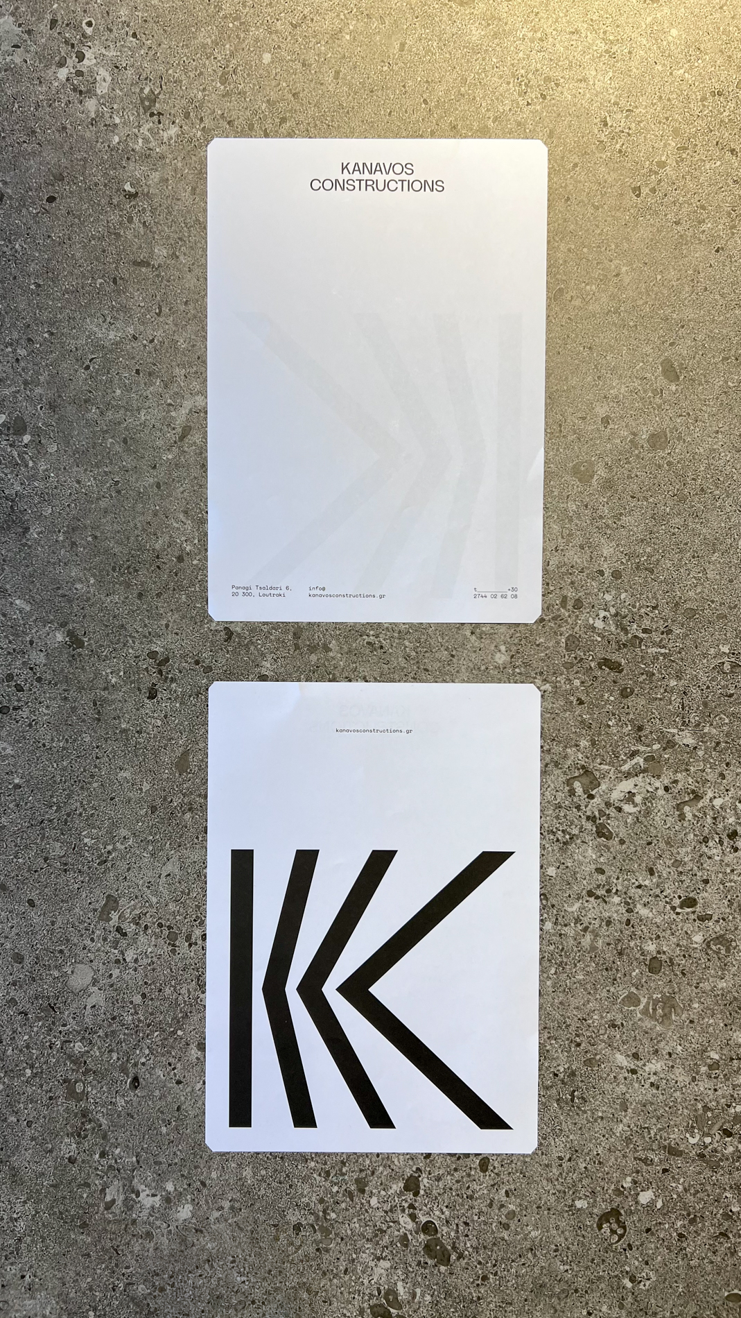 Kanavos Constructions letterhead and business card on stone