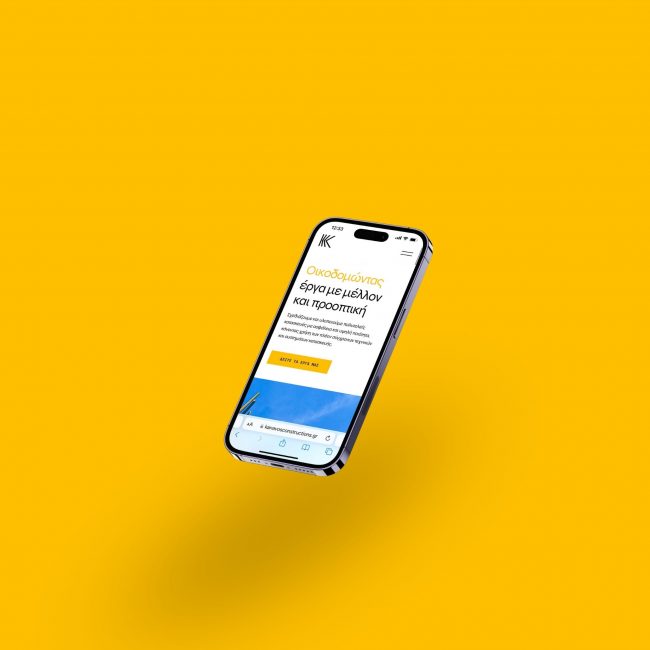 The Kanavos Constructions website on a phone, on yellow