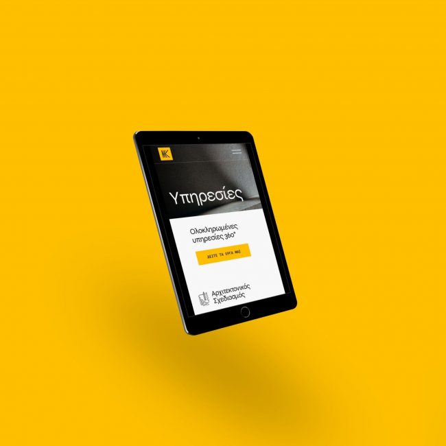 The Kanavos Constructions website on a tablet, on yellow