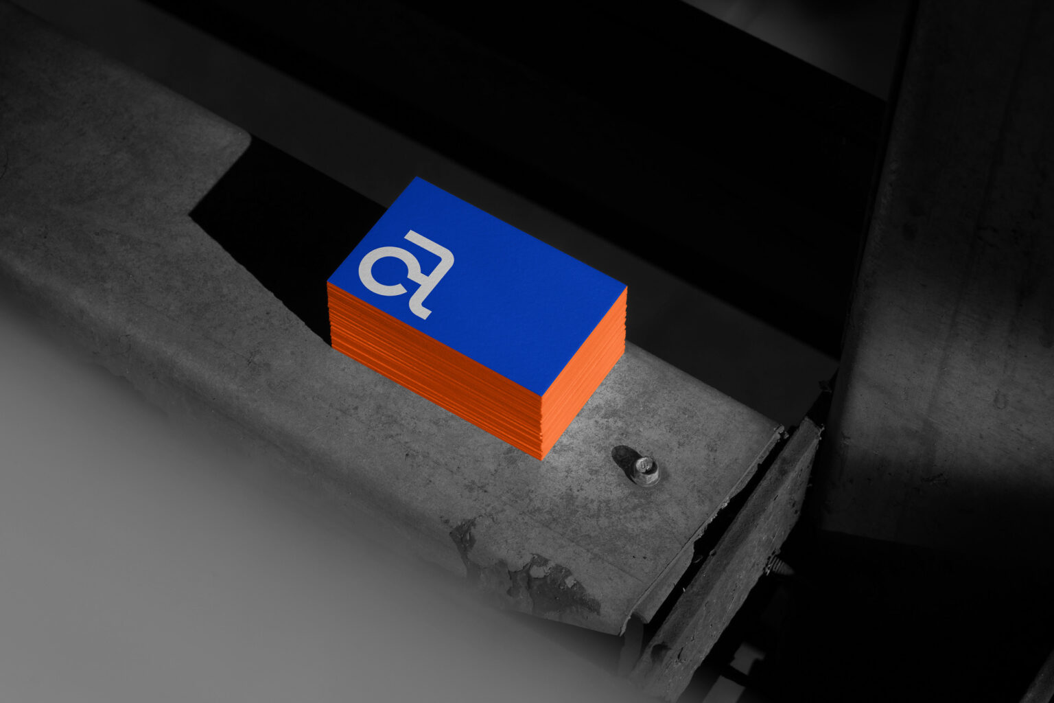Aggelou Constructions business cards with the AC symbol in blue and orange