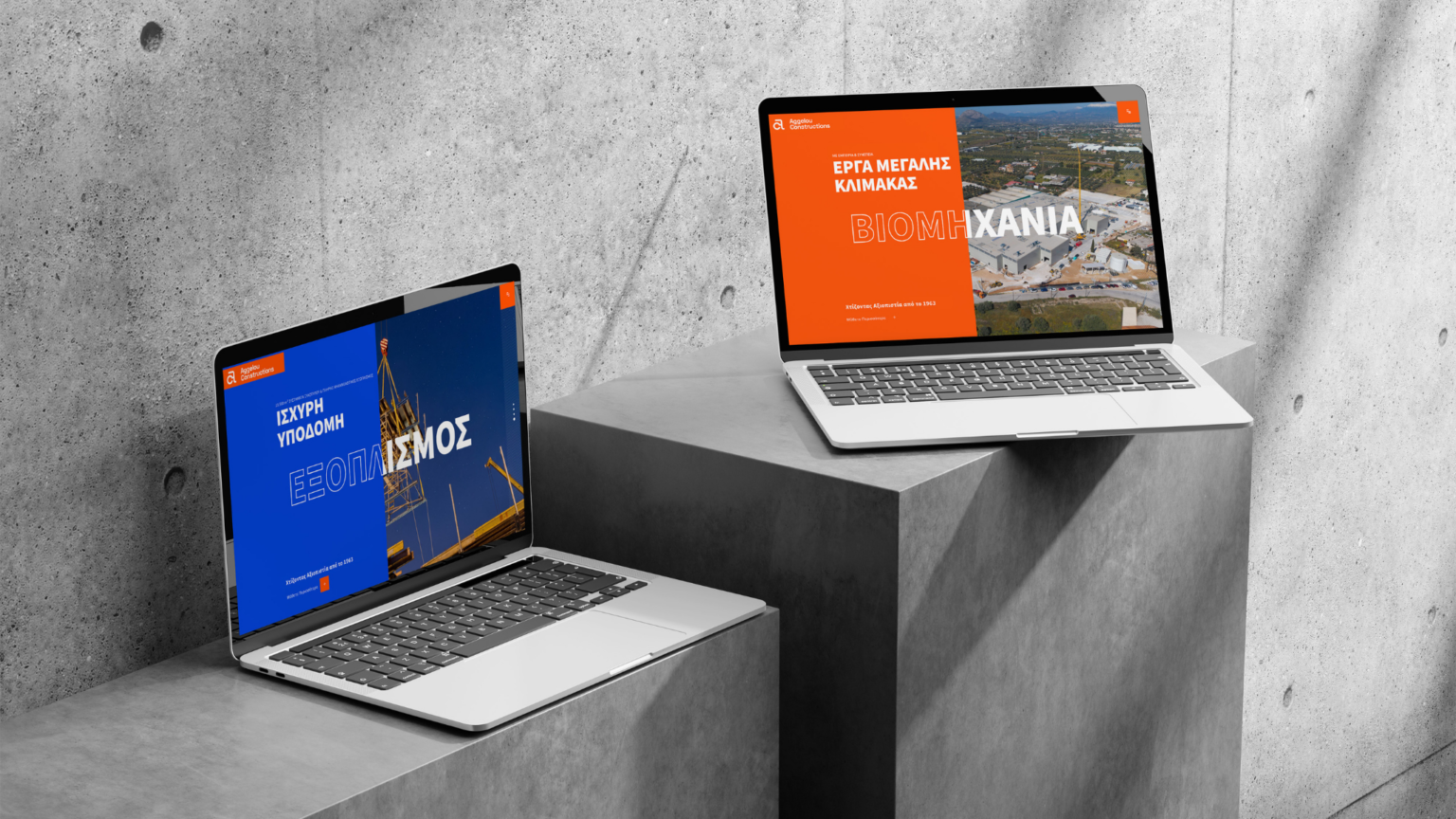 Aggelou Constructions website on two laptops on concrete plinths